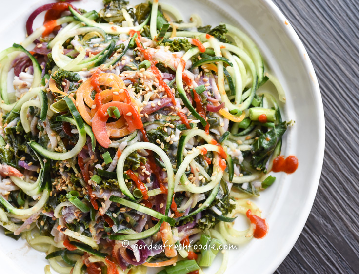 Bowl of Cucumber Noodle Salad Topped With Siracha.